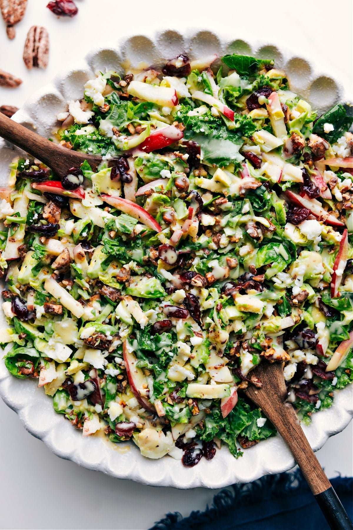 Bowl of Brussels Sprout Salad Recipe tossed with dressing and ready to eat.