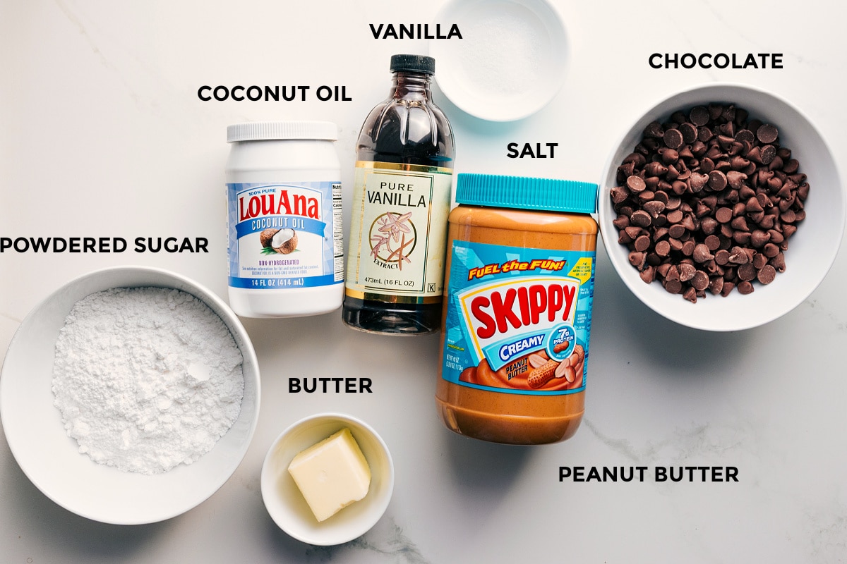 Ingredients In Buckeye Candy Recipe Ingredients in this recipe prepped out for easy assembly including powdered sugar, coconut oil, vanilla, butter, salt, peanut butter, and chocolate.