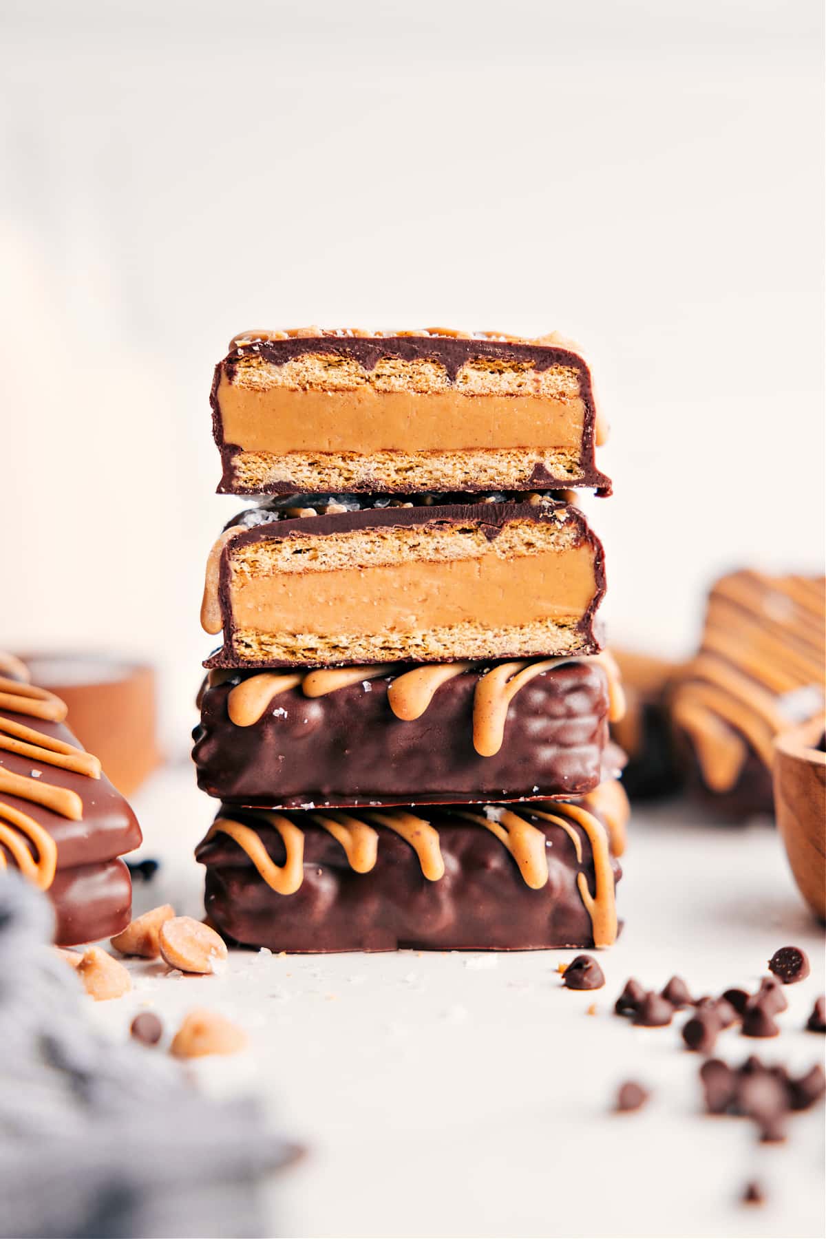 Buckeye Graham Crackers Are The Ultimate Holiday Treat Stack of Buckeye Graham Crackers with one broken open showing creamy peanut butter filling.