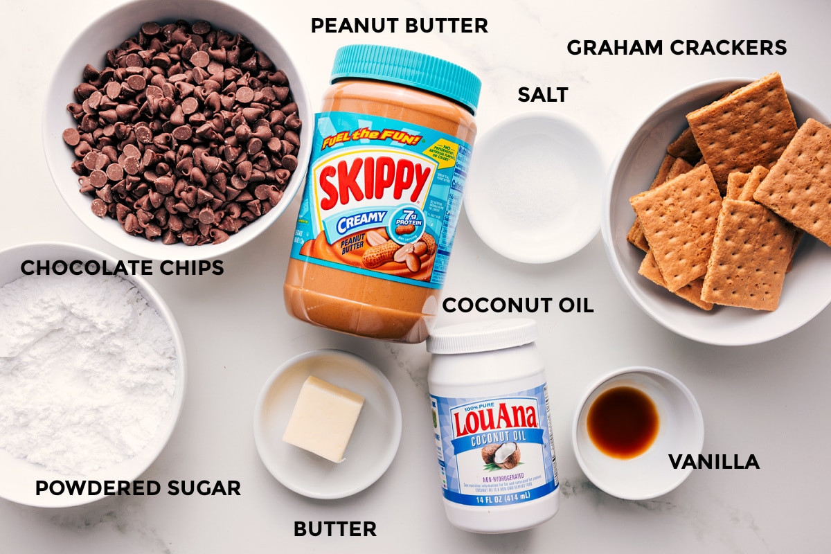 Ingredients In Buckeye Graham Crackers All the ingredients in this recipe prepped out for easy assembly including the chocolate chips, powdered sugar, butter, peanut butter, coconut oil, salt, vanilla, and graham crackers.