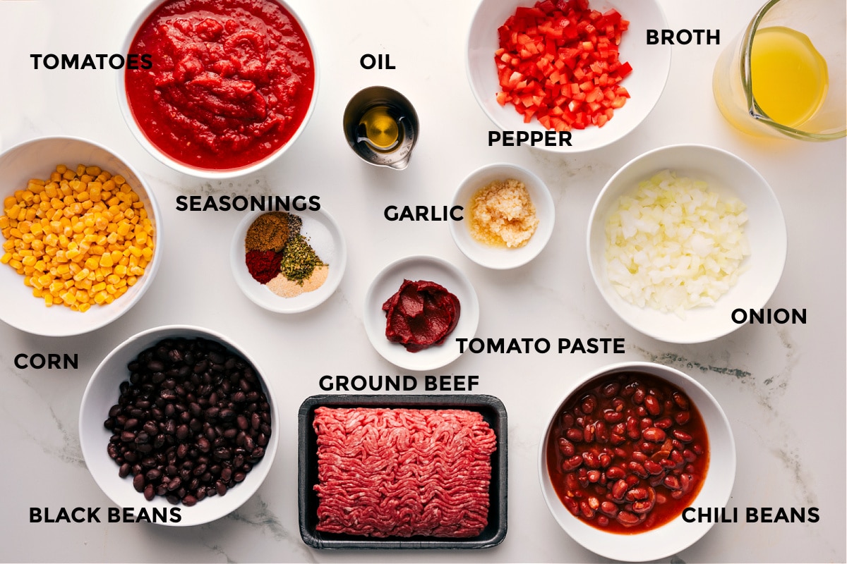 Ingredients In Cornbread Casserole Recipe The ingredients in this recipe prepped out for easy assembly including the corn, black beans, tomatoes, seasonings, oil, ground beef, garlic, peppers, onions, chili beans, and broth.