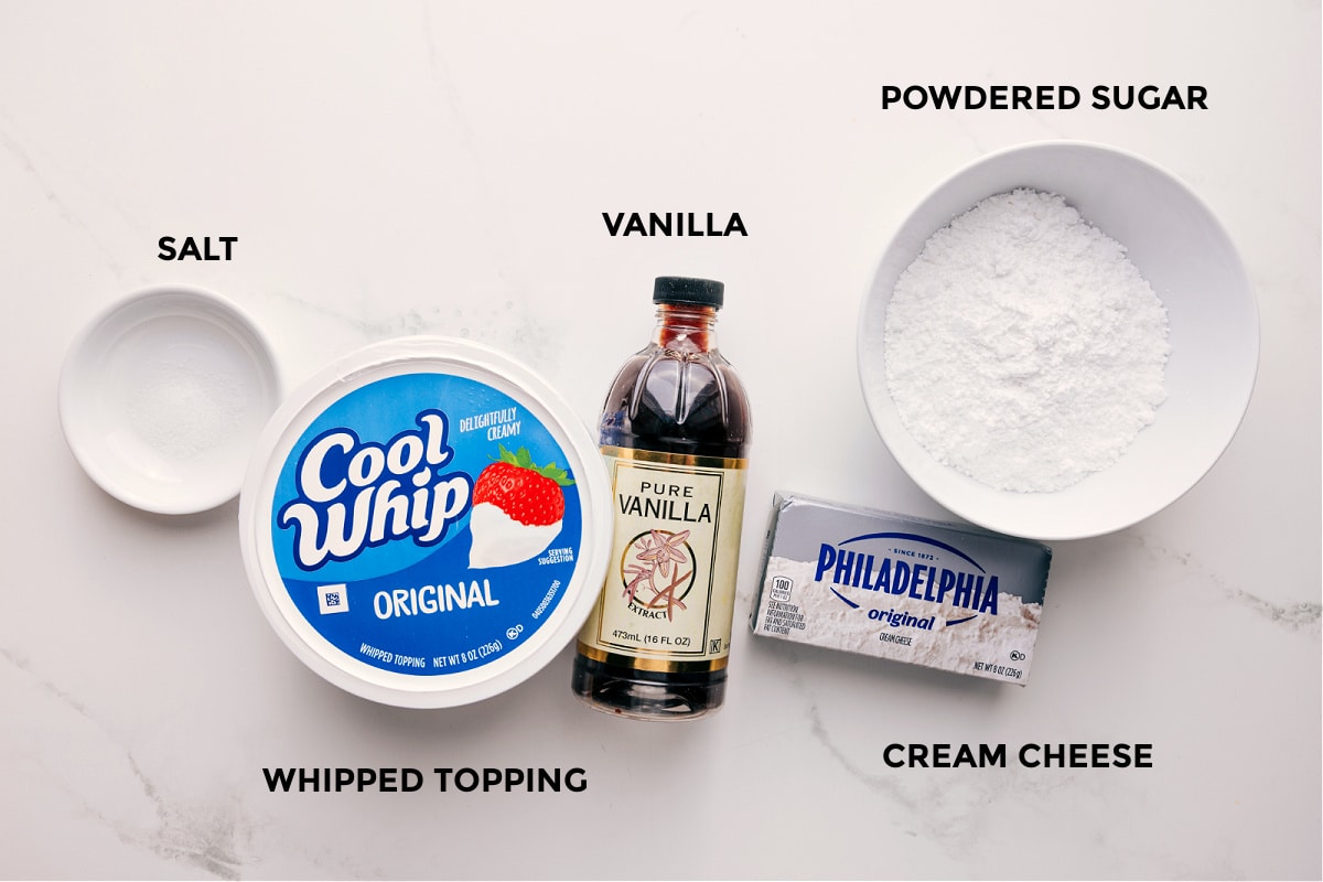 Ingredients In This Cheesecake Dip All the ingredients prepped out for easy assembly including the cream cheese, vanilla, whipped topping, salt, and powdered sugar.