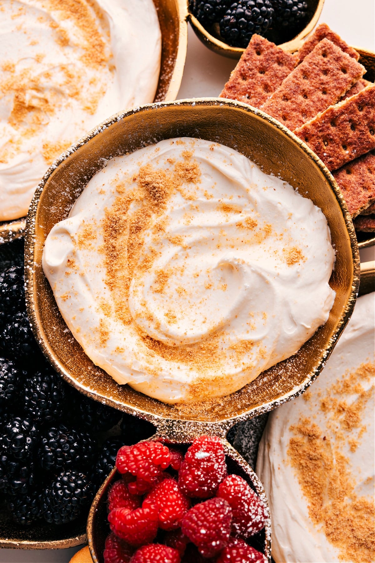 Simple And Delicious Cheesecake Dip Cheesecake Dip with fresh graham crackers sprinkled on top and berries all around to dip in.