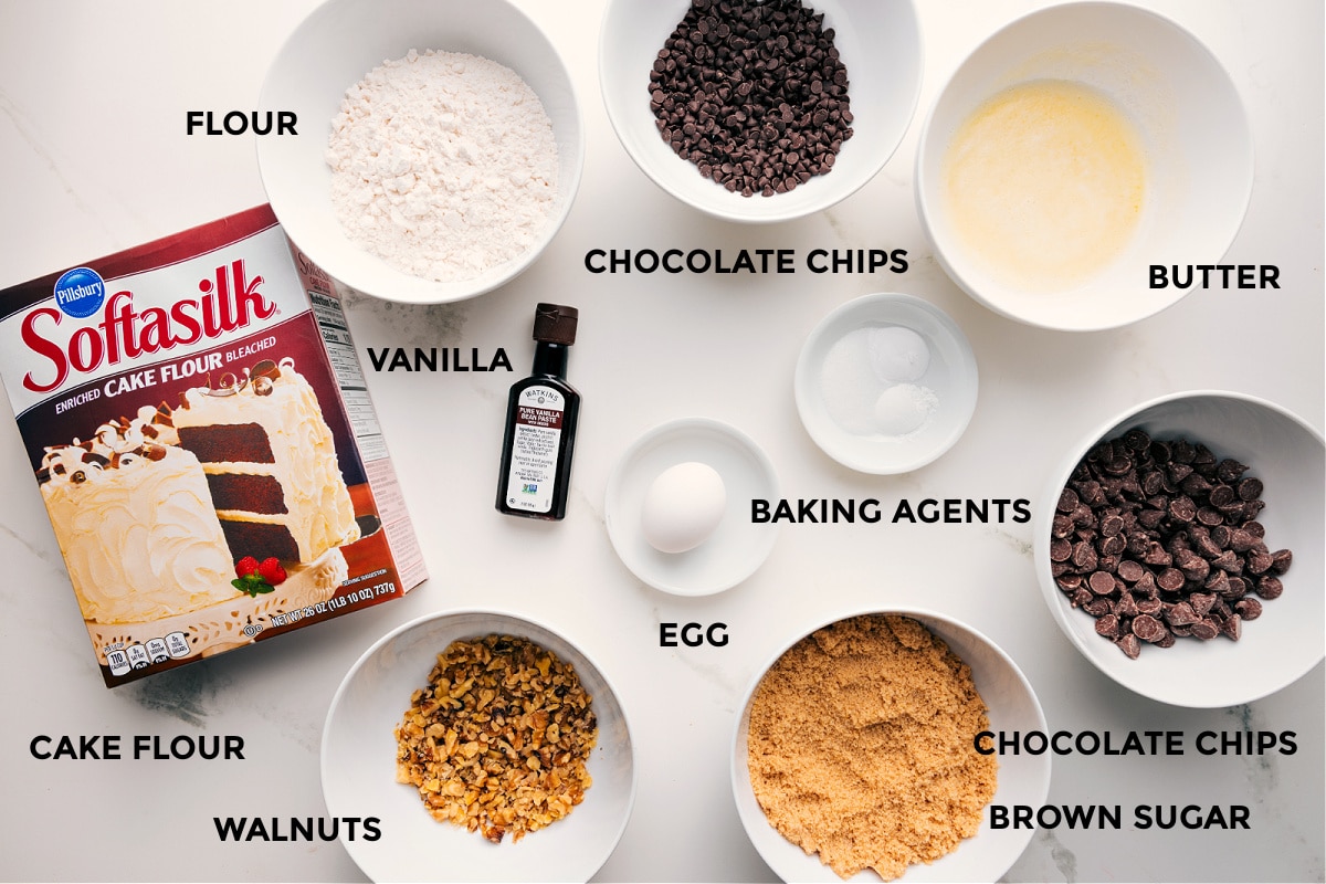 Ingredients In Levain Cookie Recipe All the ingredients in this recipe prepped out for easy assembly including cake flour, flour, walnuts, vanilla, egg, brown sugar, chocolate chips, butter, baking agents, and chocolate chips.