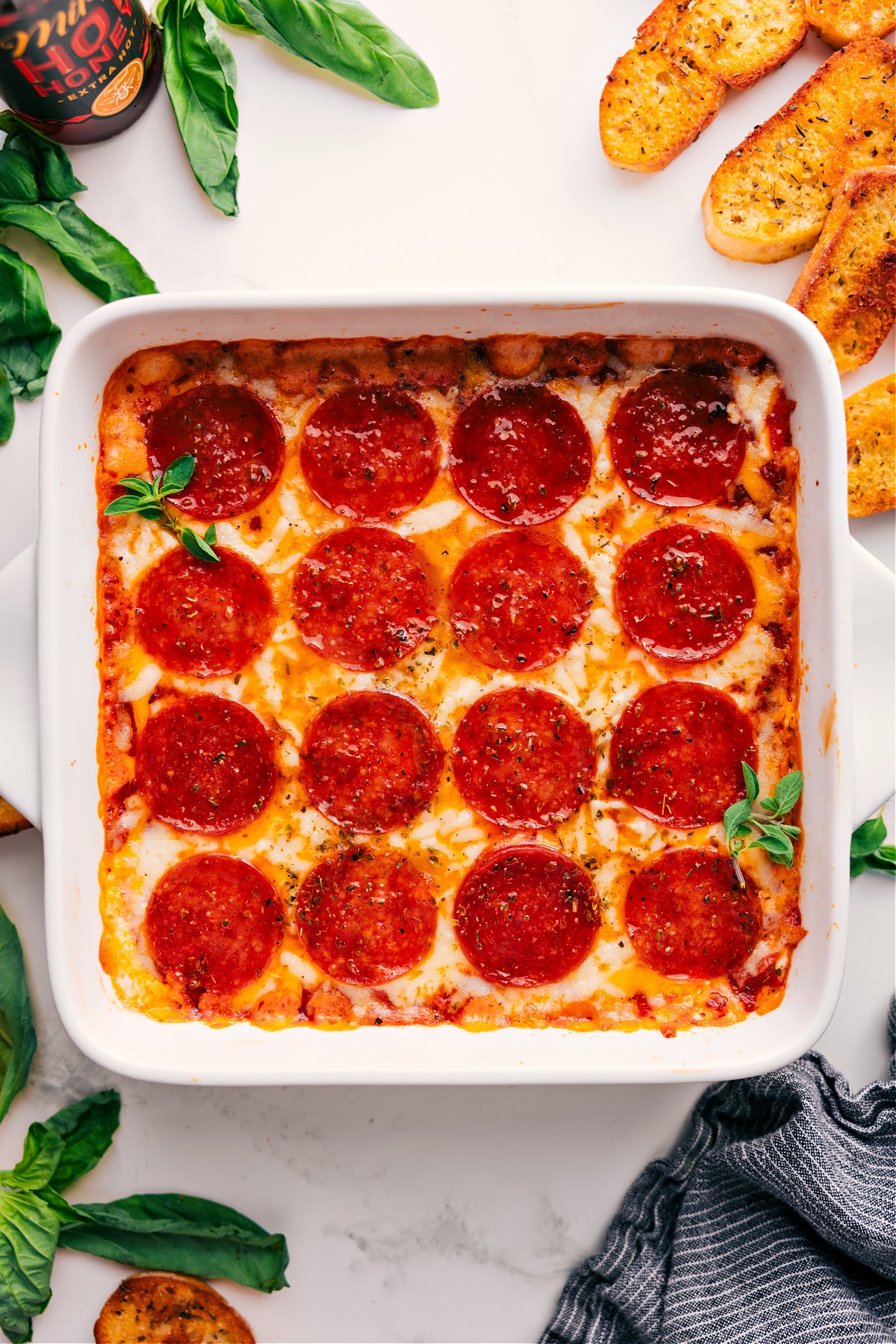 Pizza Dip Recipe fresh out of the oven with fresh basil on top.