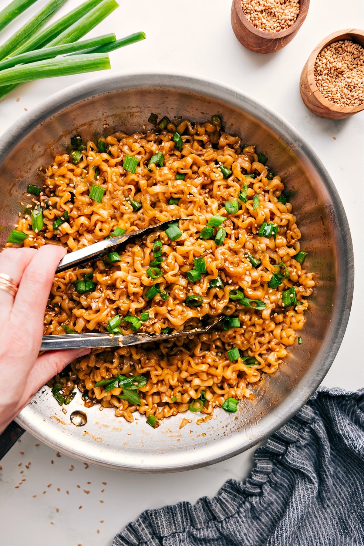 Asian Noodle Recipe in a bowl with fresh green onions and sesame seeds on top.