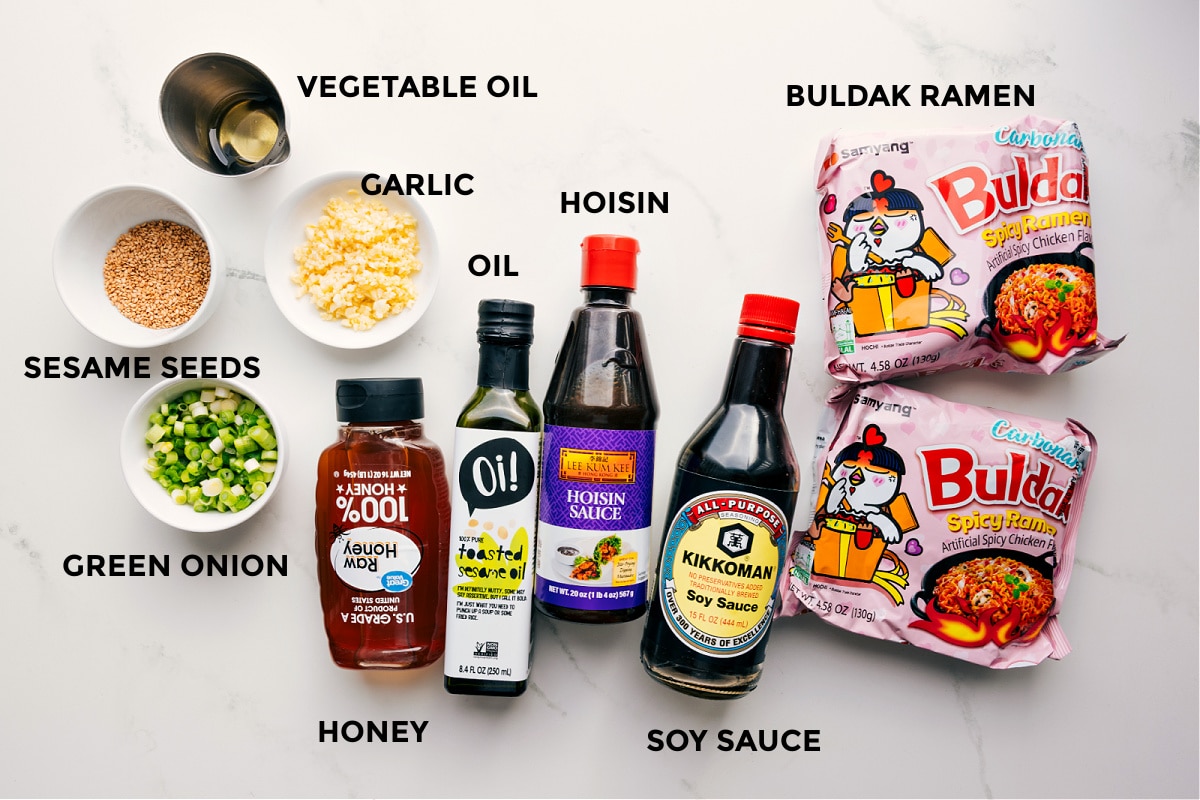Ingredients In Asian Noodle Recipe All the ingredients in this recipe prepped out for easy assembly including the sesame seeds, green onion, vegetable oil, garlic, honey, sesame oil, hoisin, soy sauce, and Buldak ramen.