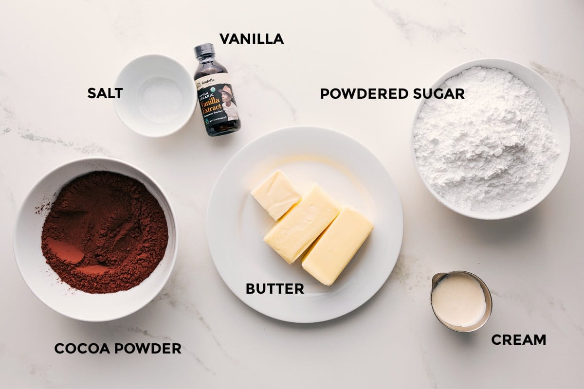 Ingredients In Chocolate Buttercream Frosting Recipe All the ingredients in this recipe prepped out for easy assembly including the cocoa powder, salt, vanilla, butter, powdered sugar, and cream.