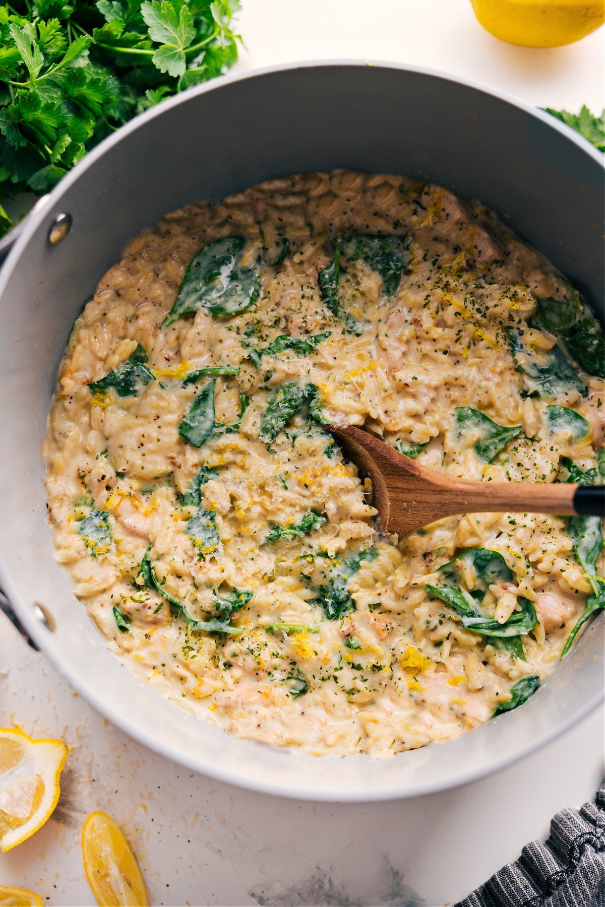 Lemon Chicken Orzo Recipe in the pot with a spoonful coming out.