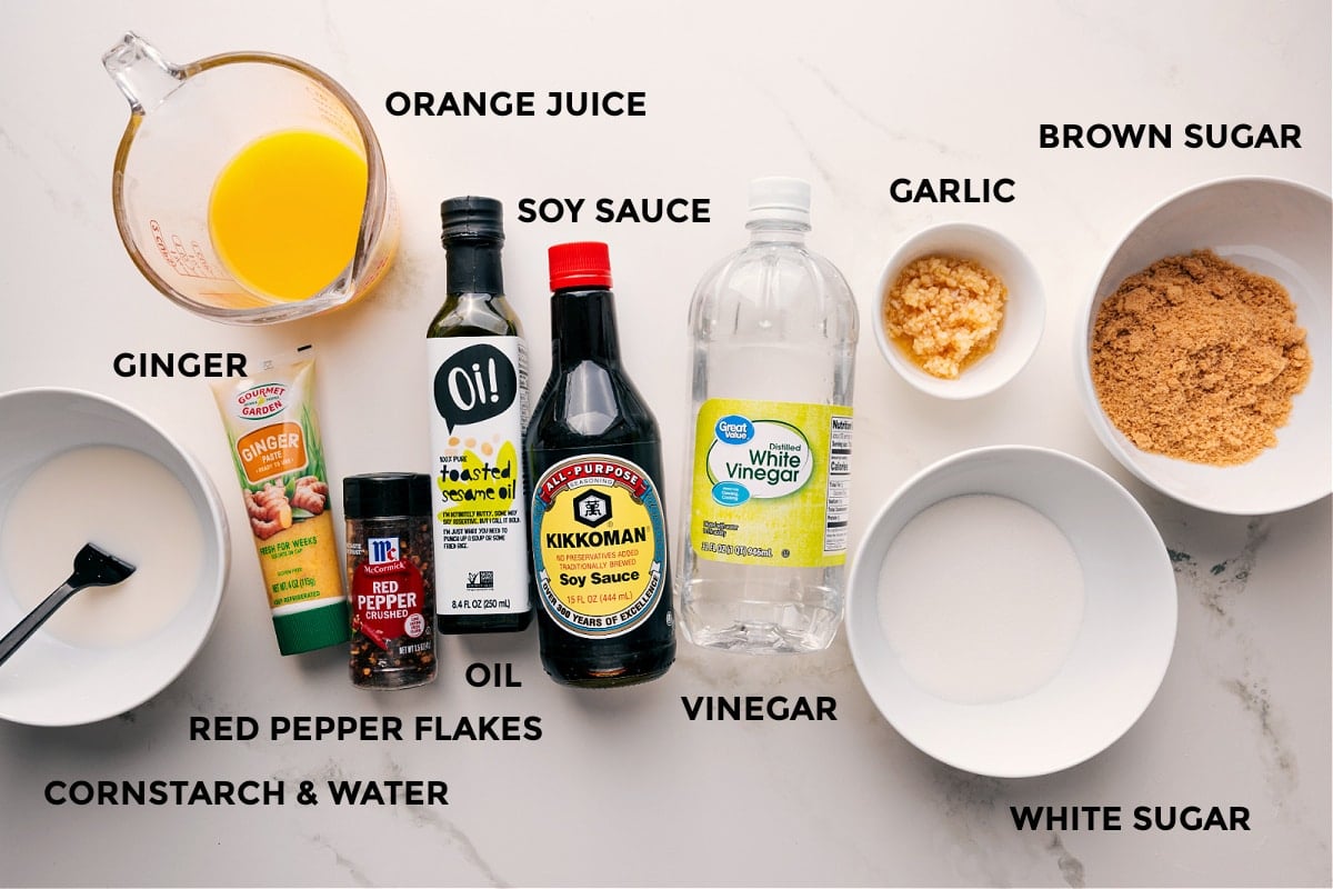 Ingredients To Make The Flavorful Orange Chicken Sauce All ingredients prepped for this sauce including cornstarch, water, red pepper flakes, ginger, oil, orange juice, soy sauce, vinegar, garlic, brown sugar, and white sugar.