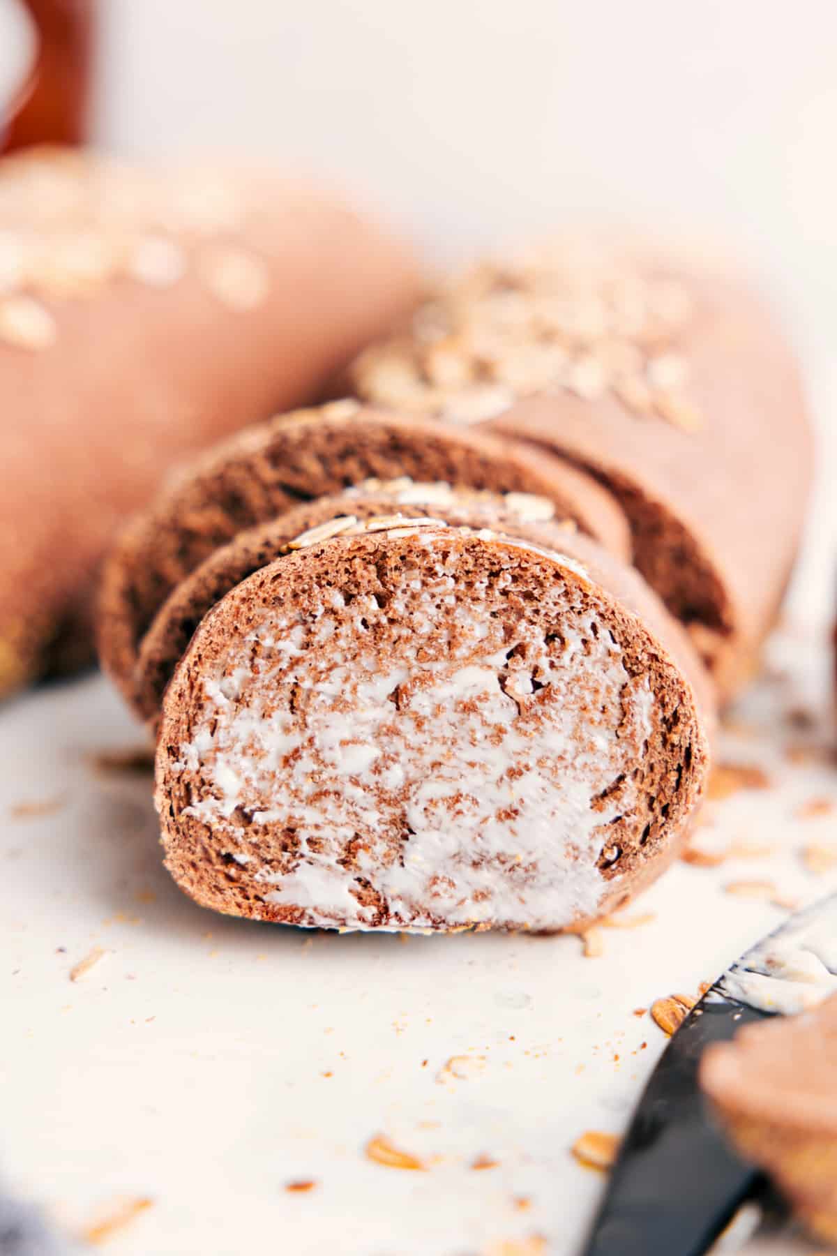 Brown bread recipe sliced and served with butter spread on top.