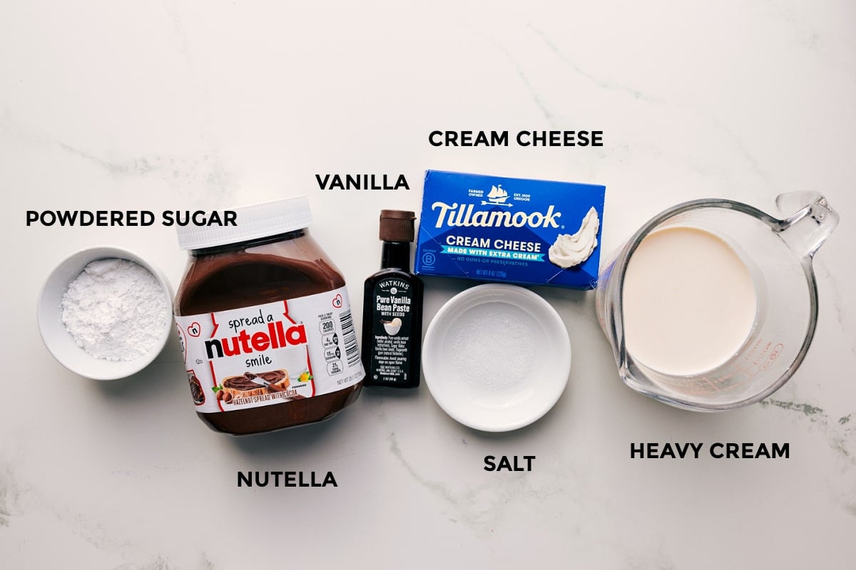 Ingredients In Chocolate Fruit Dip All the ingredients in this recipe prepped out for easy assembly including the powdered sugar, Nutella, vanilla, cream cheese, salt, and heavy cream.