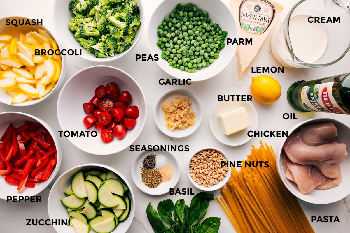 Ingredients In Chicken Primavera All the ingredients in this recipe prepped out for easy assembly including the squash, pepper, broccoli, zucchini, tomato, peas, garlic, seasonings, pine nuts, pasta, chicken, oil, lemon, cream, butter, parmesan, and lemon.