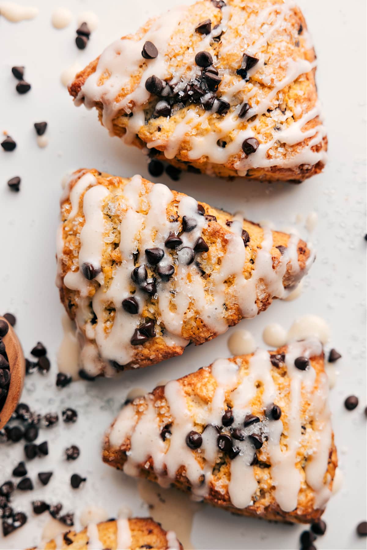Chocolate chip scones topped with a glaze and extra chocolate chips.