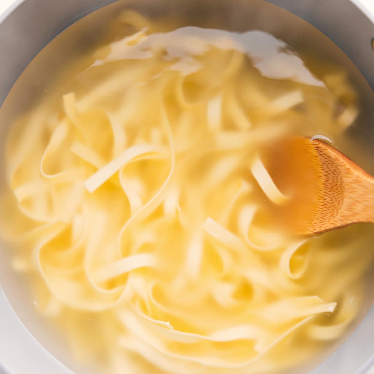 Cooking The Fettuccine To Al Dente The fettuccine noodles boiled in a pot for this Olive Garden fettuccine Alfredo recipe.