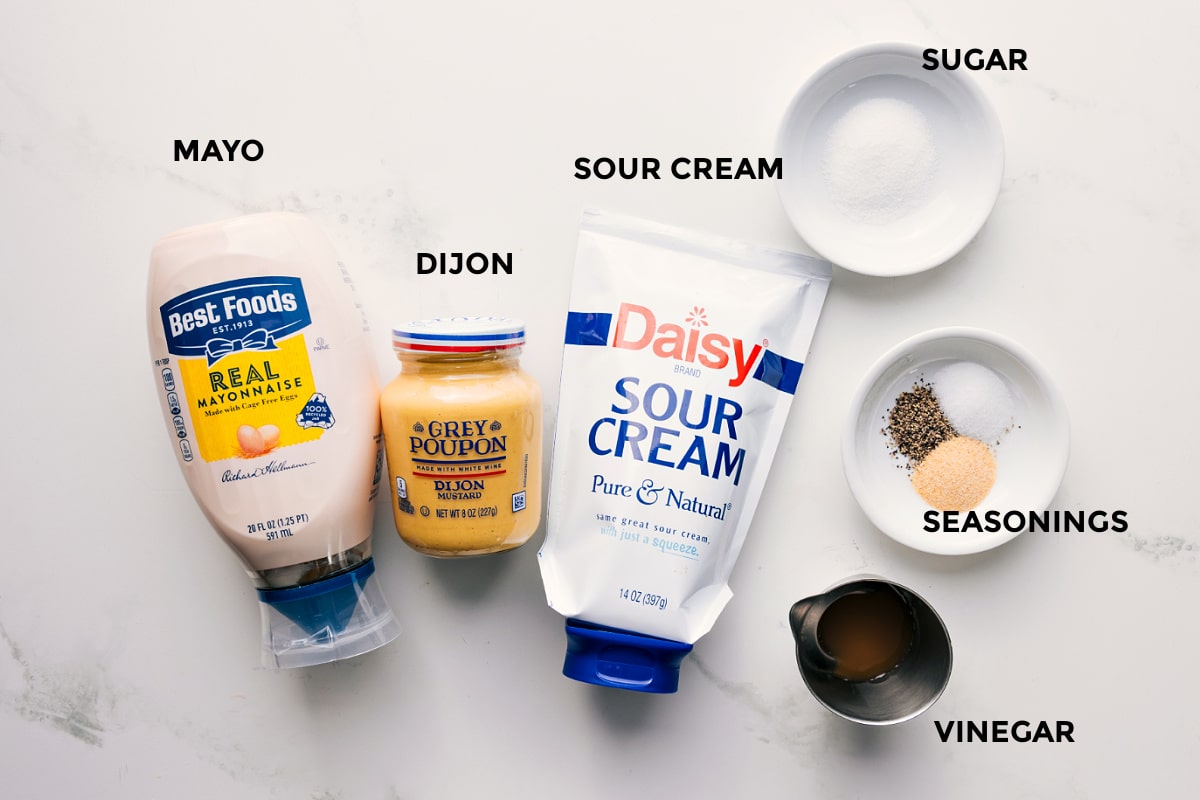 The Ingredients In This Pea Salad Dressing Prepped Out The dressing ingredients for this pea salad recipe prepped for easy assembly including mayo, Dijon mustard, sour cream, sugar, vinegar, and seasonings.