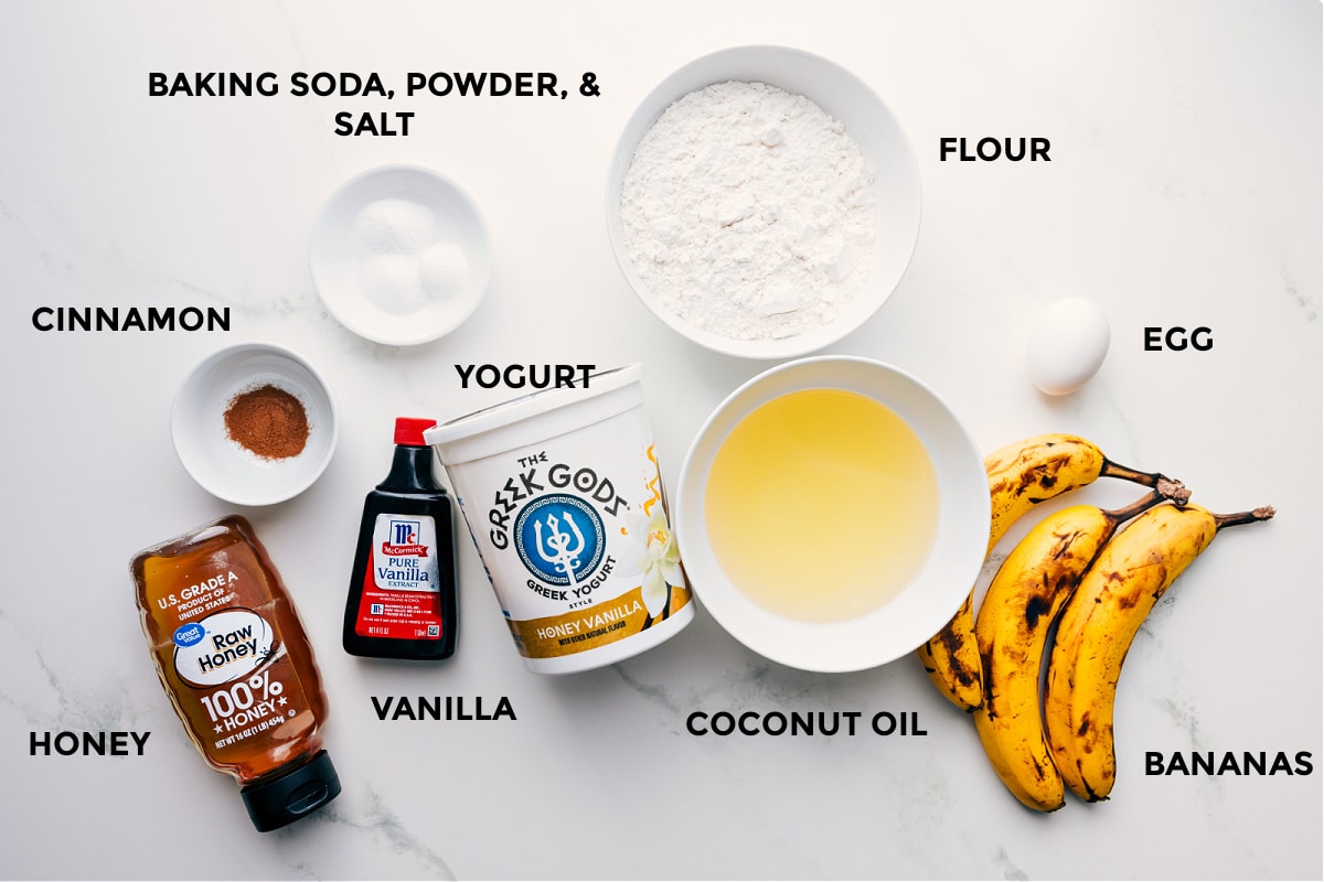 Ingredients In Banana Crumb Muffins All the ingredients in this recipe prepped out for easy assembly including the honey, cinnamon, baking soda, powder, salt, vanilla, yogurt, flour, coconut oil, egg, and bananas.