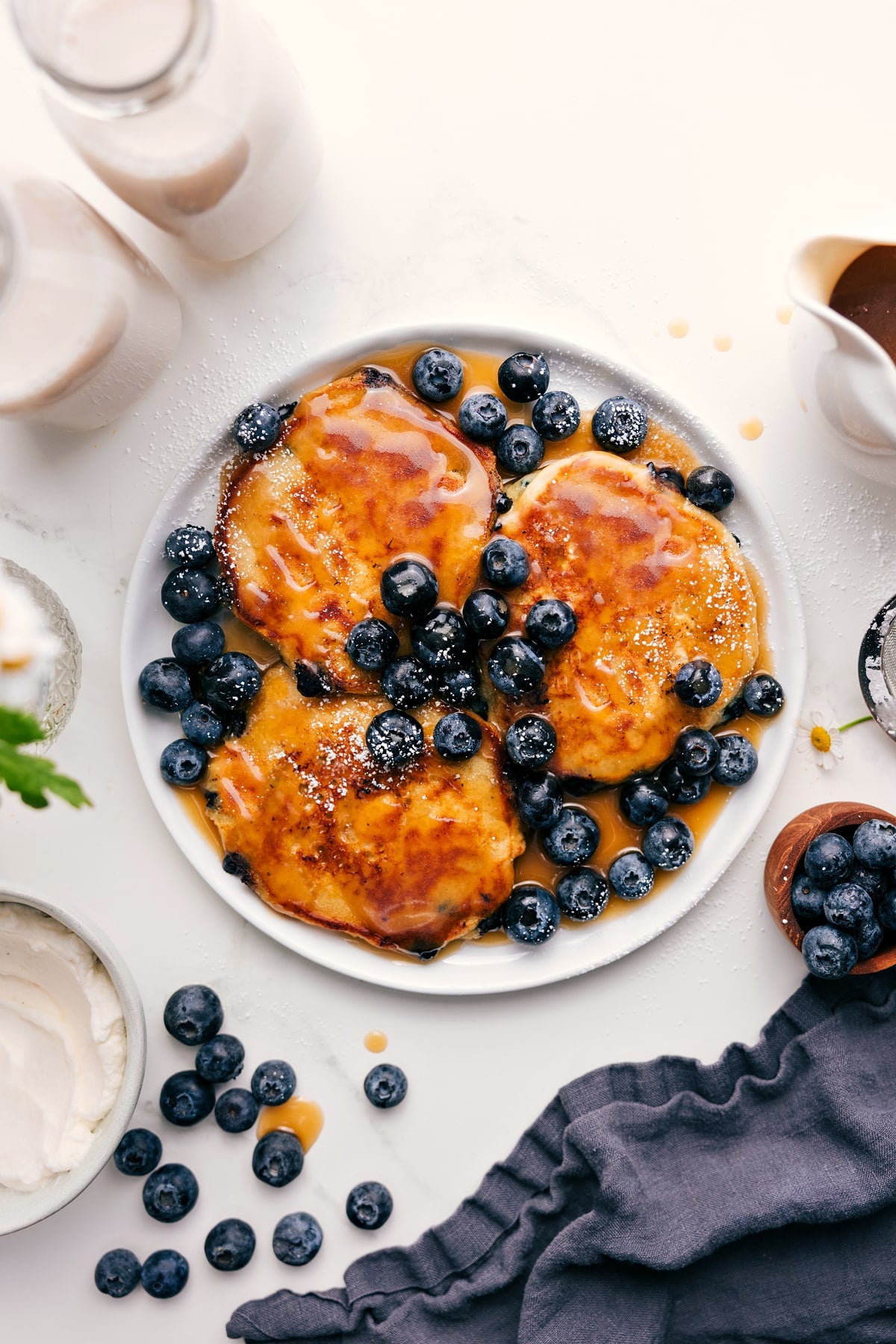 Blueberry Pancake Recipe topped with fresh blueberries and pancake syrup.