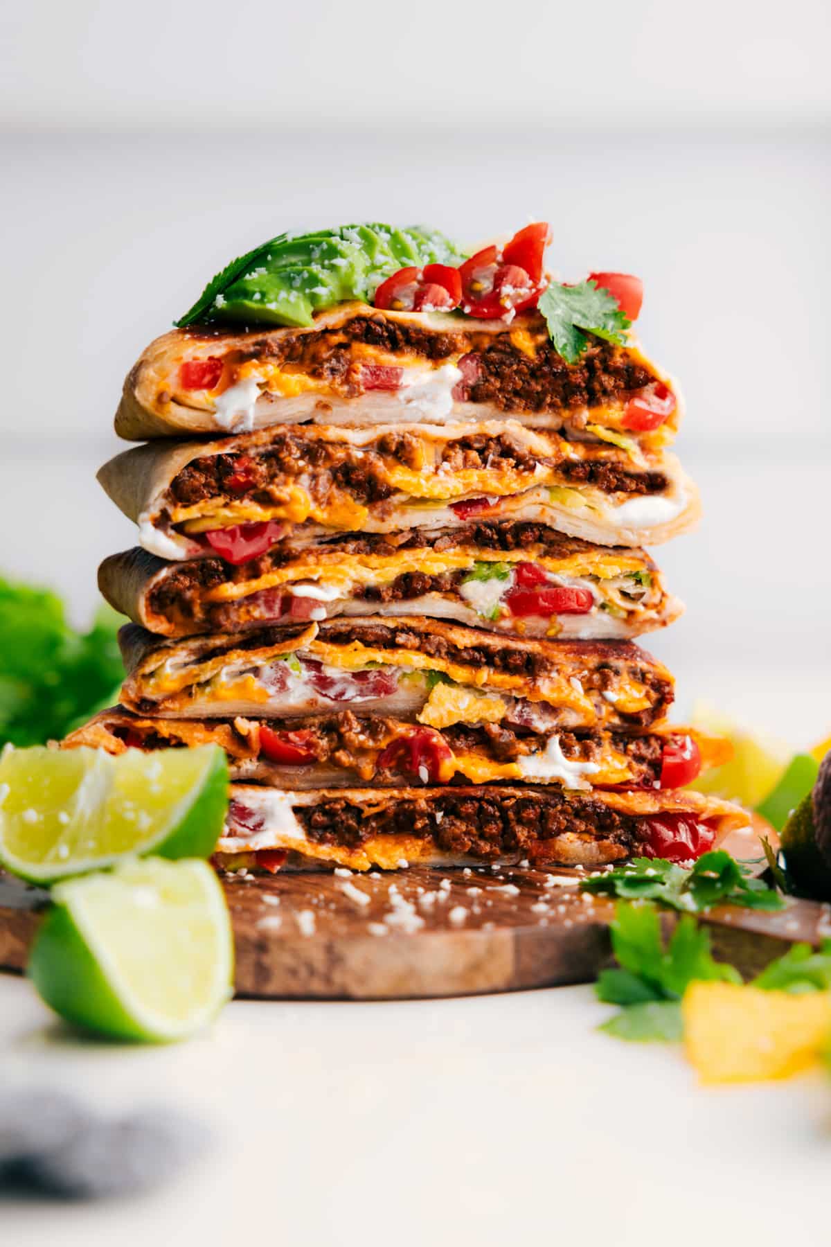 Taco Bell Copycat Crunchwrap Supreme Recipe Crunchwrap Supreme Recipe cut in half and stacked on top of each other, finished with fresh toppings like tomatoes and avocado.