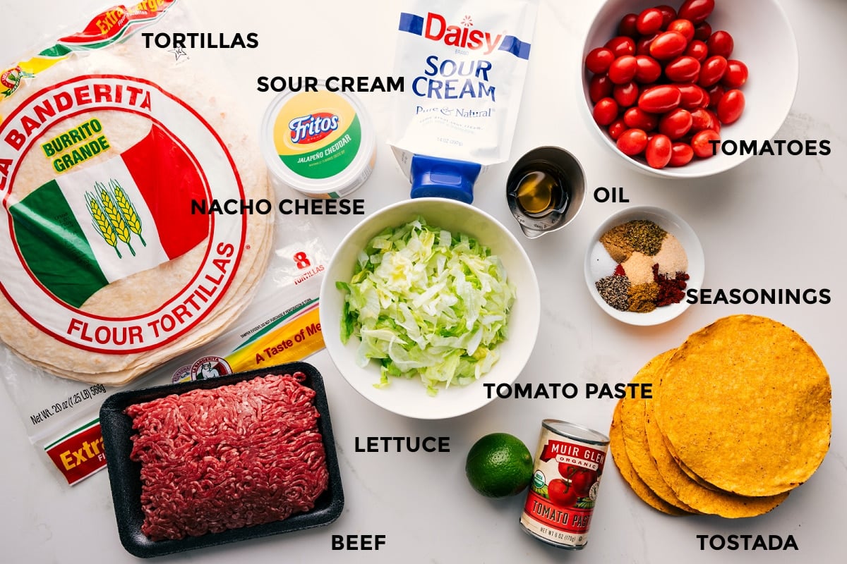 Ingredients In This Crunchwrap Supreme Recipe All the ingredients in this recipe prepped out for easy assembly including the tortillas, beef, lettuce, tomato paste, lime, seasonings, tomatoes, oil, sour cream, and nacho cheese.