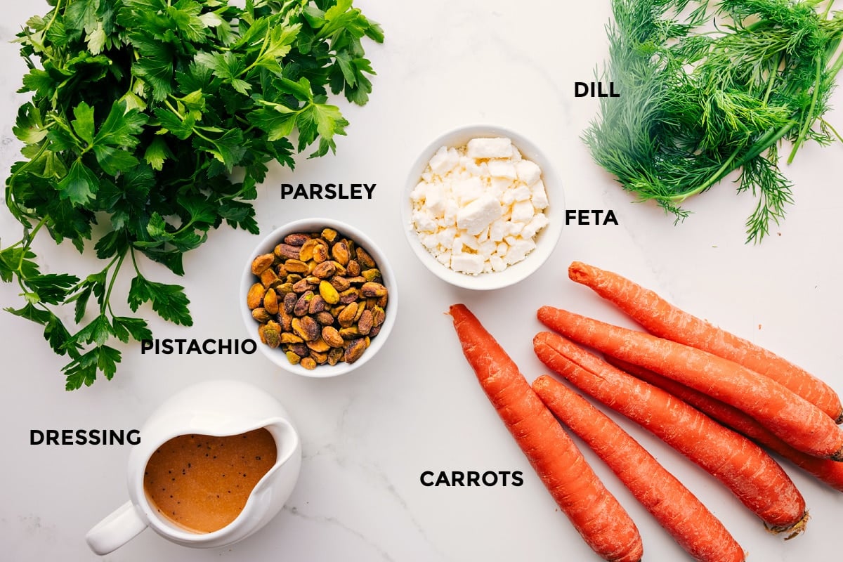 Ingredients In Ribbon Carrot Salad All the ingredients in this recipe prepped out for easy assembly including the parsley, dressing, pistachio, feta, carrots, and dill.