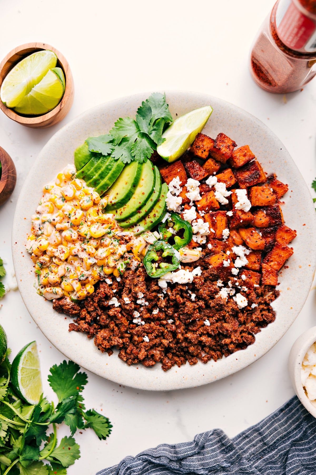 The Perfect Meal Prep: Street Corn Beef Bowl Street Corn Beef Bowl topped with crumbled cheese, Tajรญn seasoning, and sliced jalapeรฑos.