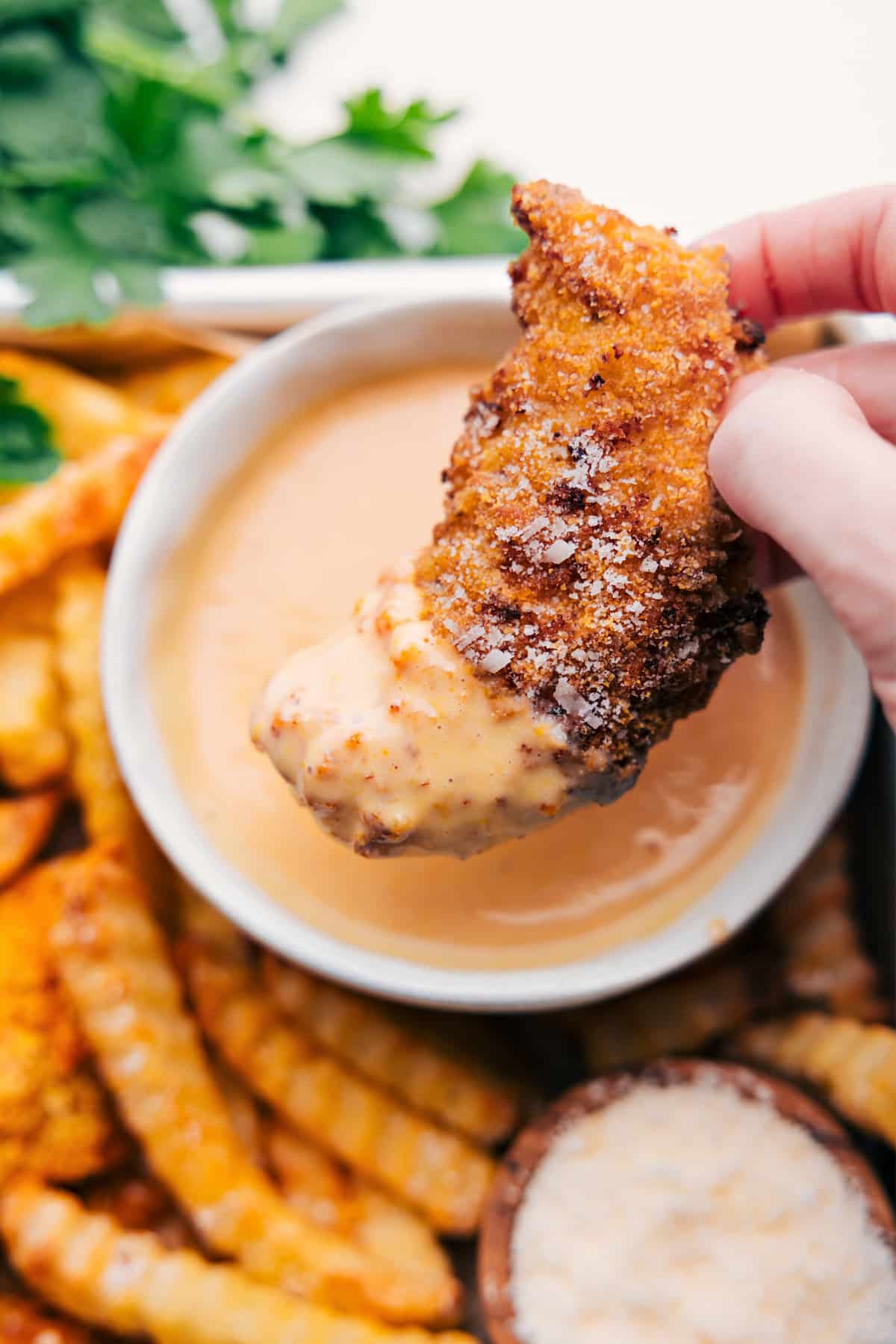 Homemade Baked Chicken Tenders Baked Chicken Tenders dipped in a delicious sauce.