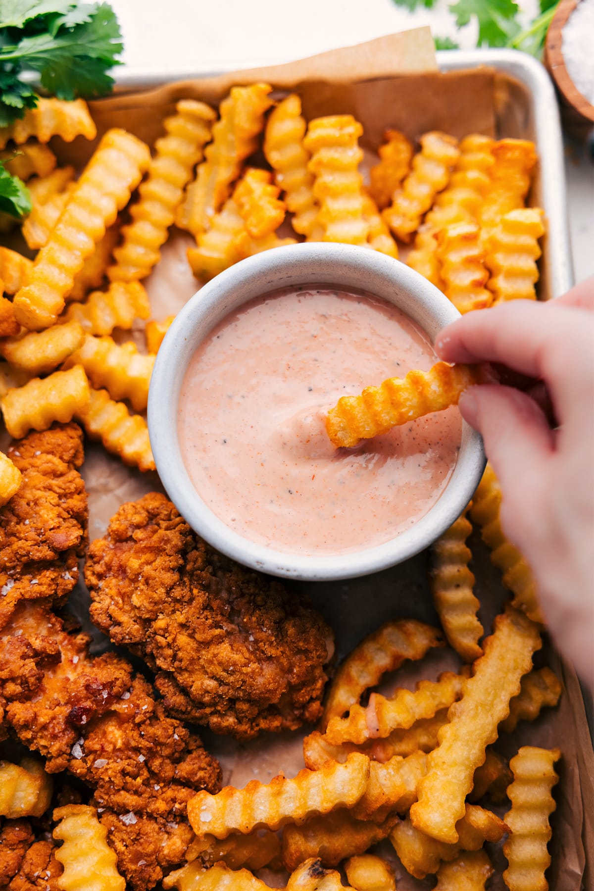 Cane's Sauce Recipe Caneโs sauce recipe in a bowl with a fry dipping into it.