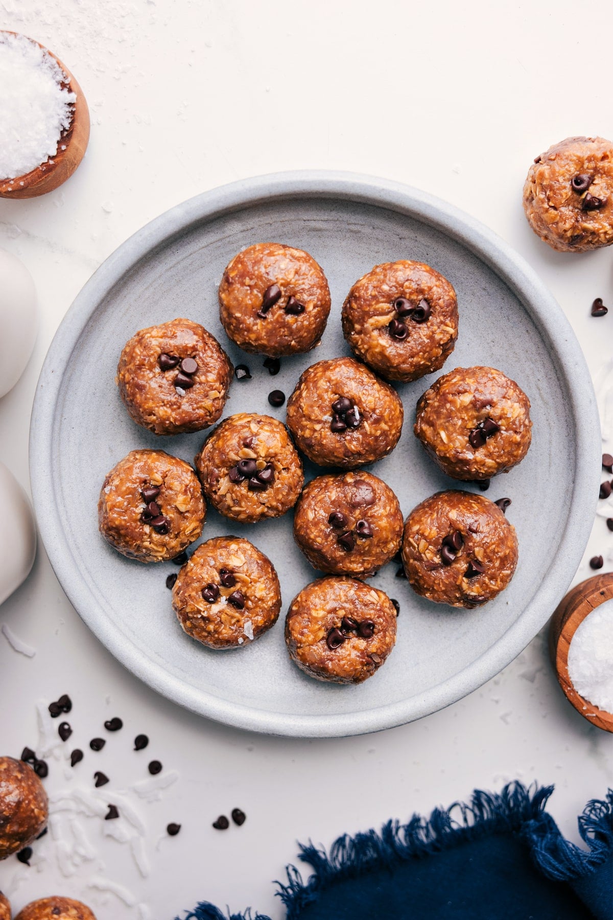 Oatmeal Energy Balls on a plate with chocolate chips pressed into each ball.