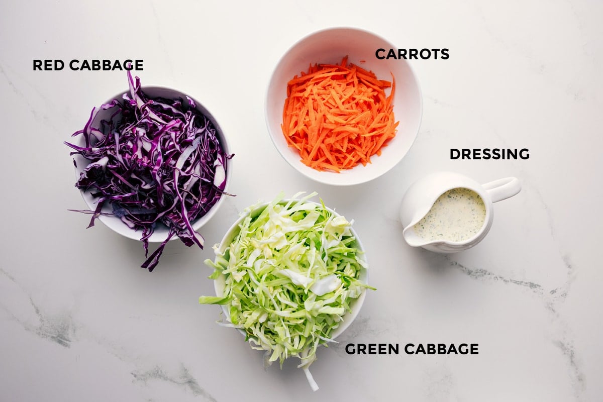 Ingredients In This Mexican Slaw Recipe All the ingredients in this recipe prepped out for easy assembly including the red cabbage, green cabbage, dressing, and carrots.