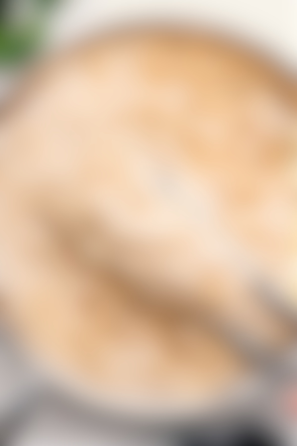 Olive Garden fettuccine alfredo in the pot with a big scoop coming out.