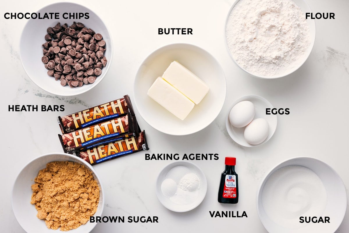 Ingredients In Heath Bar Cookies All the ingredients for this recipe for Macadamia Nut White Chocolate Cookies prepped and ready to assemble, including white chocolate, sugars, butter, eggs, flour, and baking agents.